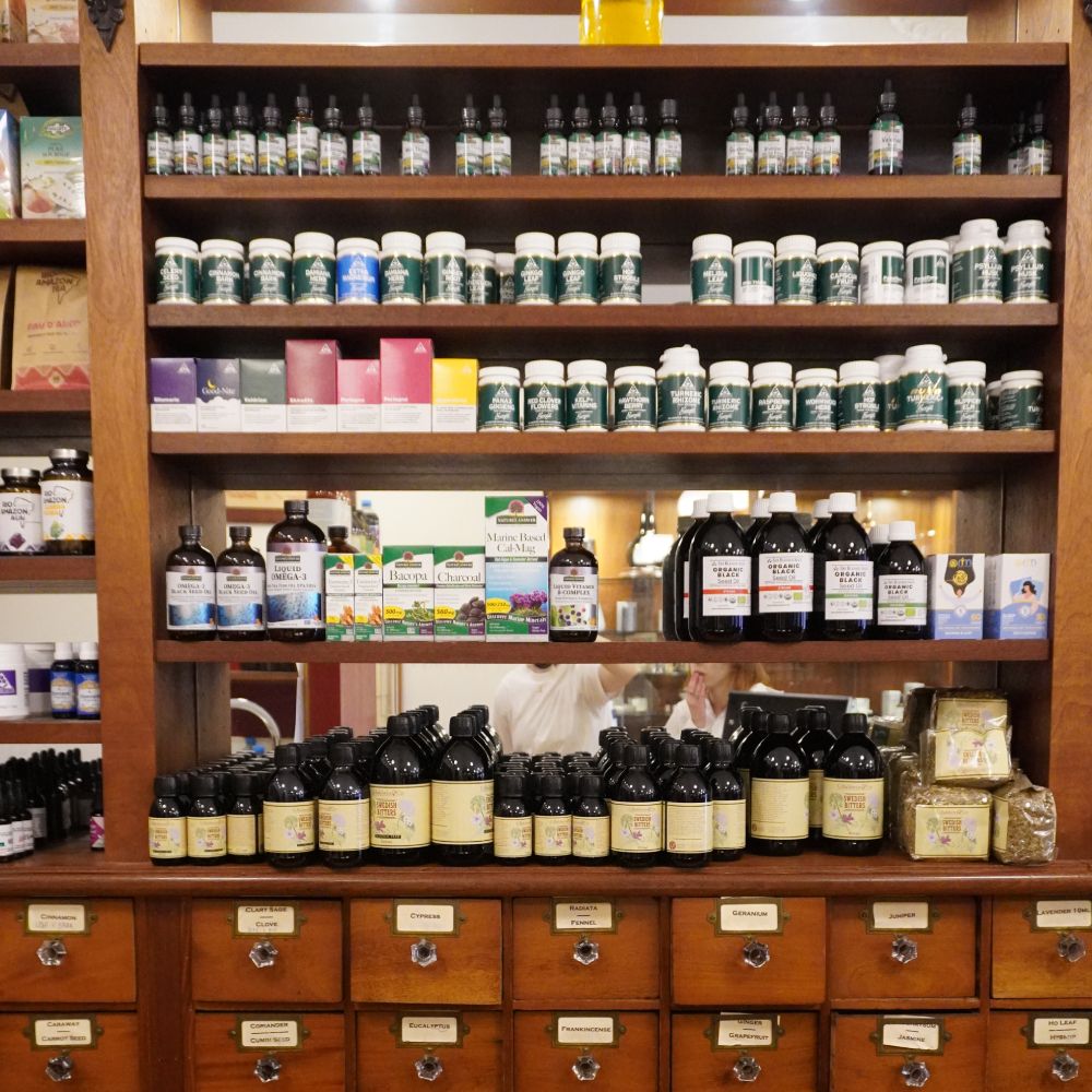  Wide array of Baldwins herbal supplements on wooden shelves.